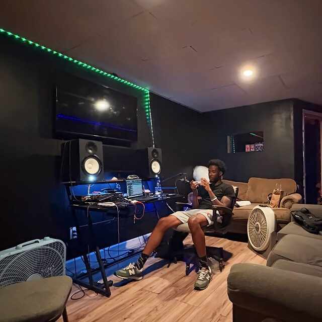 Inside the Cozi 8 Studios recording room, showing the monitor setup and RGB LED lighting